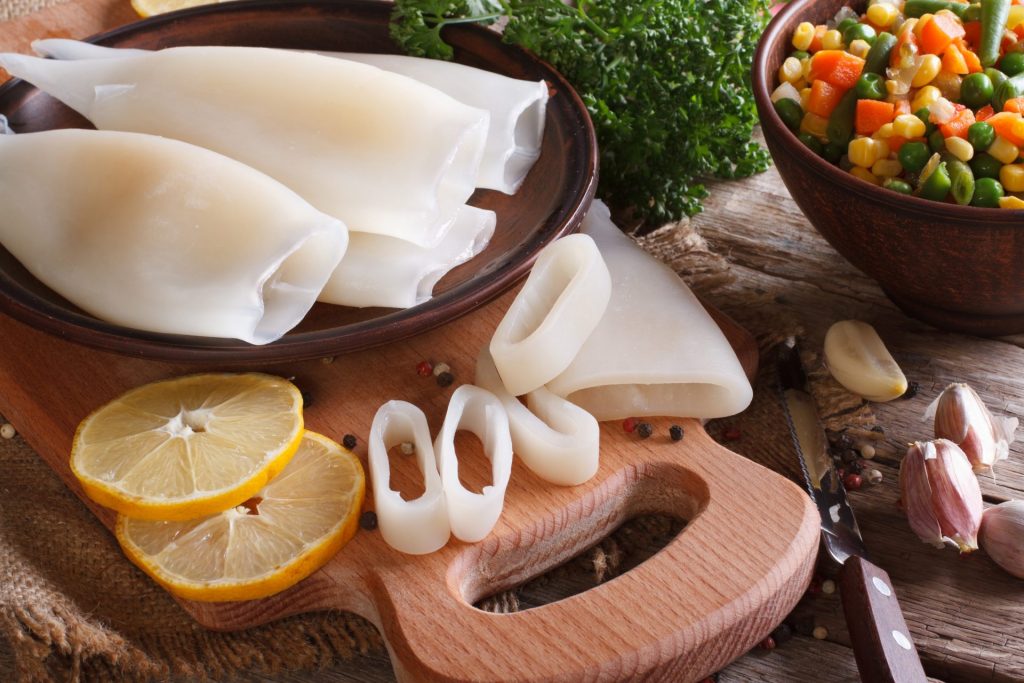 Raw squid being cut and prepared